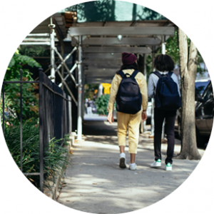 Young people walking along street