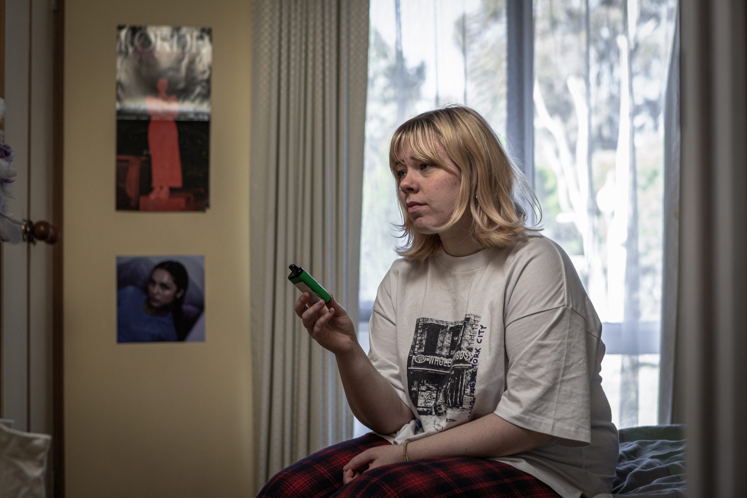 Girl anxious and stressed about vaping holding a vape